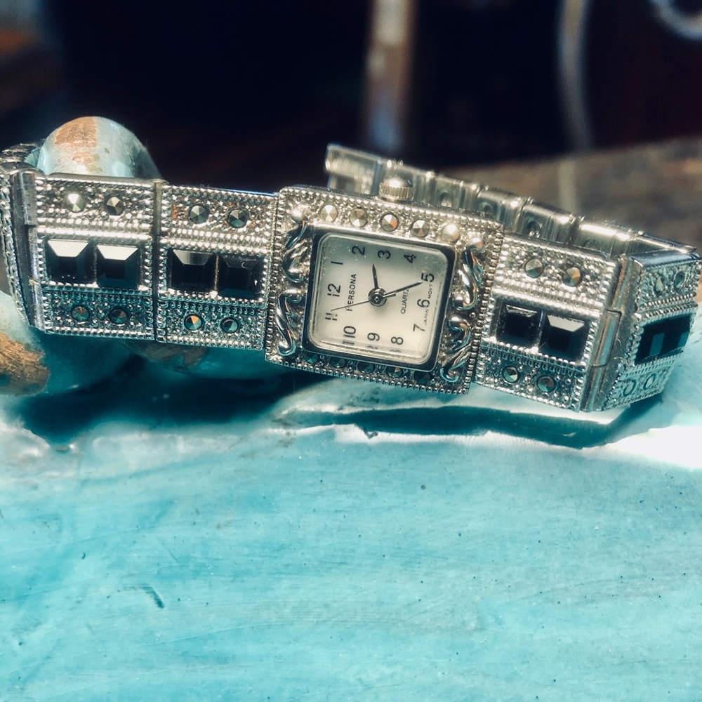 Marcasite and obsidian silver-tone watch.